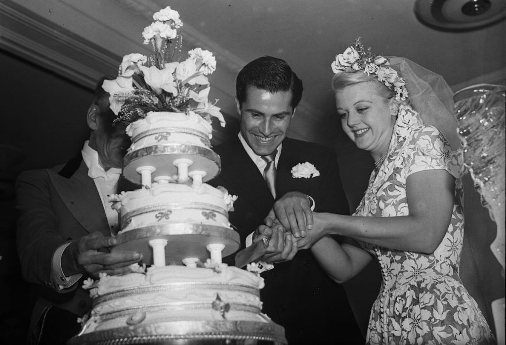 Angela Lansbury and her husband, Peter Shaw, cutting the cake at their wedding in 1949