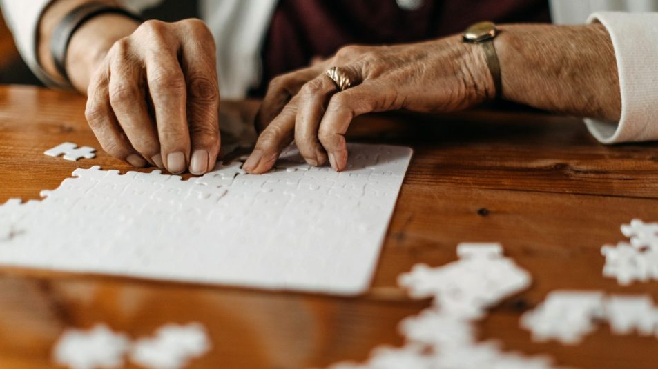 Old woman playing puzzle game