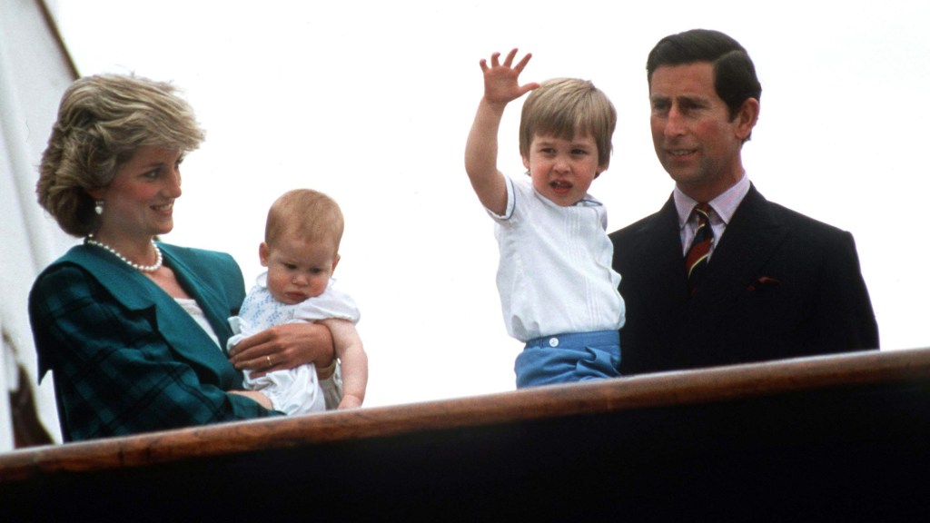 Princess Diana holding baby Prince Harry next to Prince Charles holding young Prince William