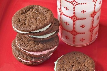 chocolate sandwich cookie stacked with glass of milk