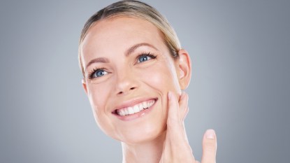 mature woman smiling with glass skin