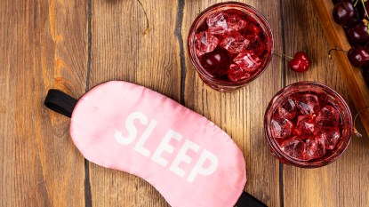 sleep mask on a table next to two beverages, which are a sleepy girl mocktail