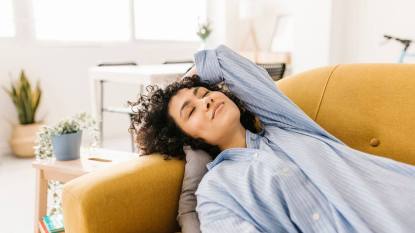 Woman on the couch figuring out how long should a nap be