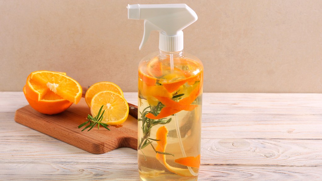 spray bottle with homemade orange cleaner in it; uses for orange peels