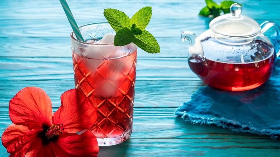 A beautiful glass of iced hibiscus tea that has many health benefits