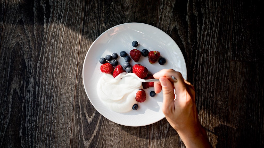 A bowl of yogurt with fruit, which isn't always safe for dogs
