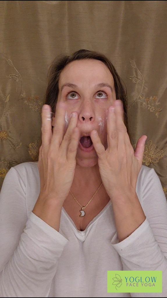 Woman spreading moisturizer in upwards direction