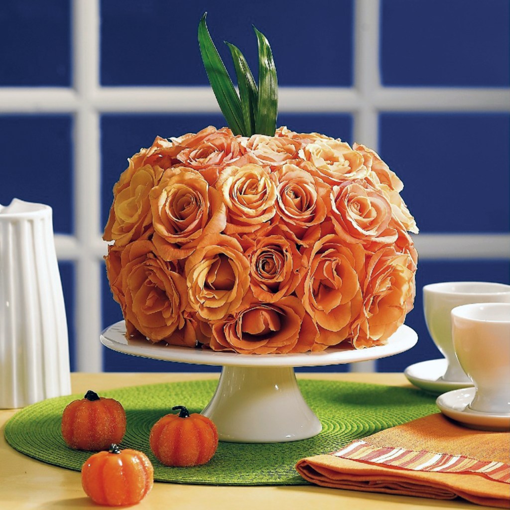 Halloween Centerpiece Ideas: Bouquet made out of orange roses and shaped like a pumpkin on cake plate