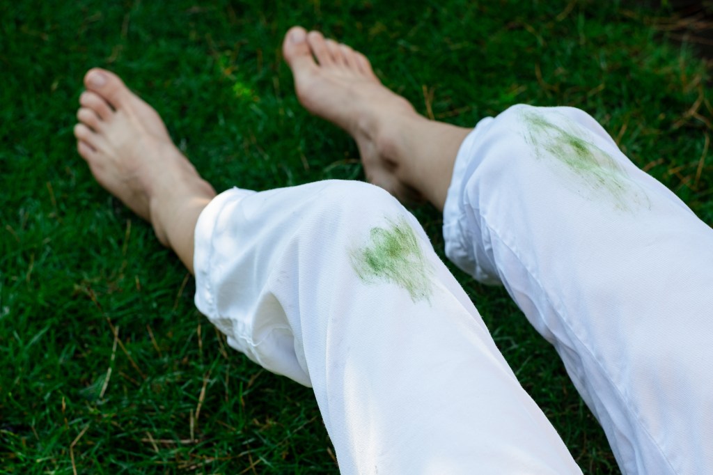 Dirty stain of fresh grass on white clothes. daily life stain concept. outdoors
