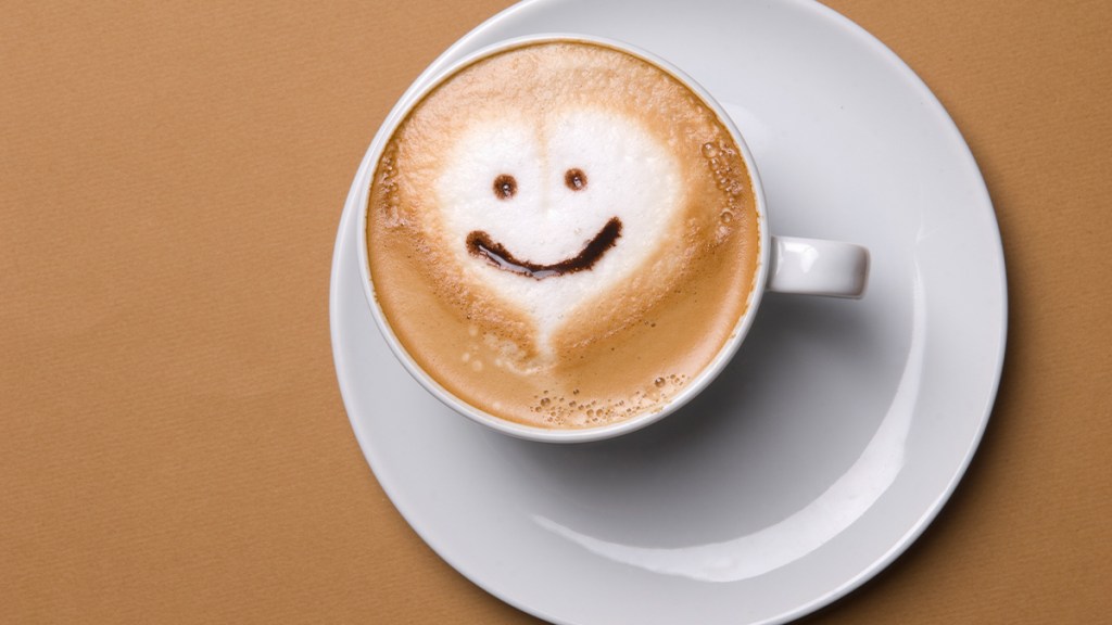 latte with a  smiley face in the foam: health benefits of one cup of coffee a day