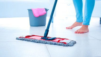 woman mopping tile floor
