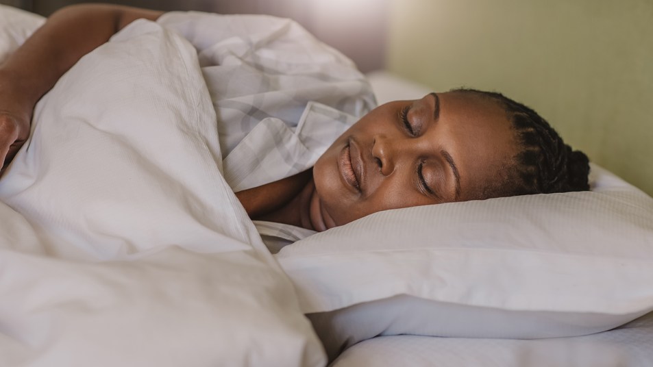 woman asleep under weighted blanket