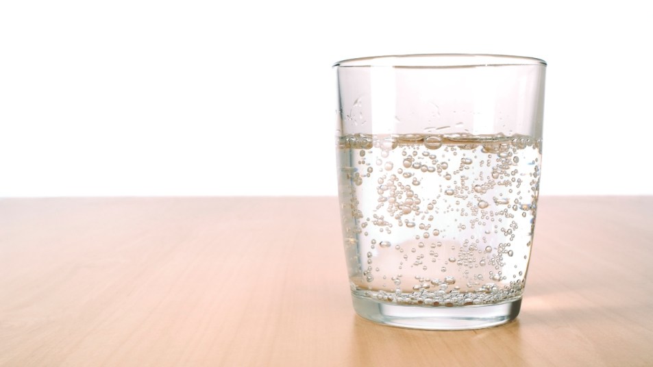 club soda seltzer water in a glass on table