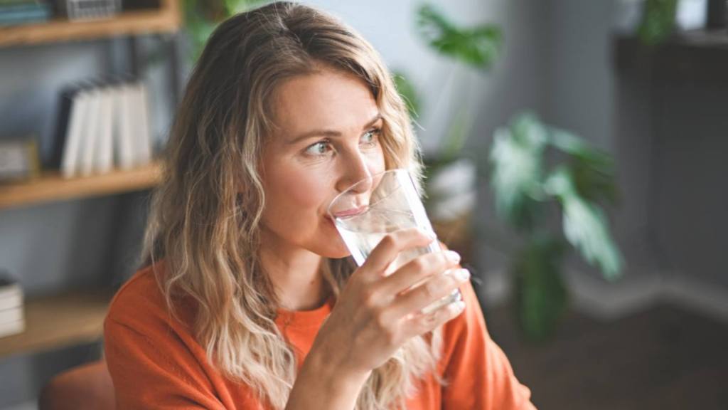 woman drinking water ; How to get rid of garlic breath