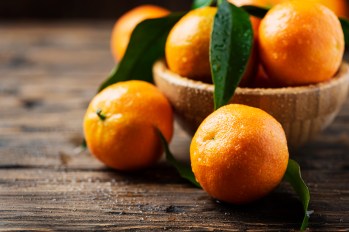Fresh sweet mandarins on the wooden table, selective focus