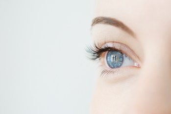 close up of a woman's eye with light shining in it