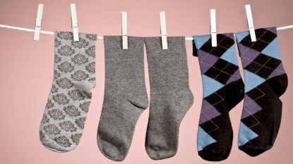 Socks on a clothesline with one missing