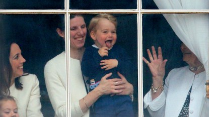 Maria Borrallo holding Prince George while he waves from a palace window