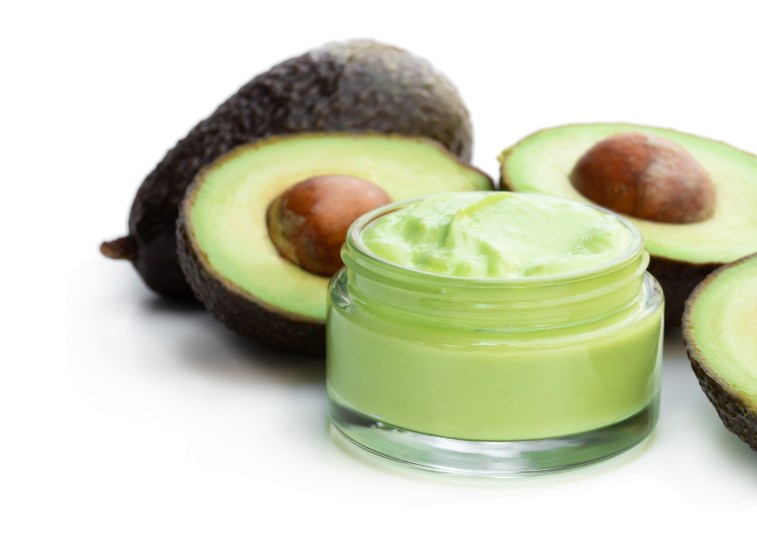 Homemade organic cosmetics with avocado on white background