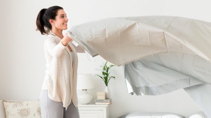 Woman making her bed