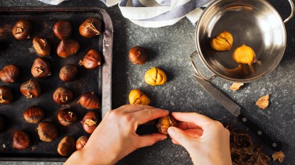 Woman shelling chestnuts