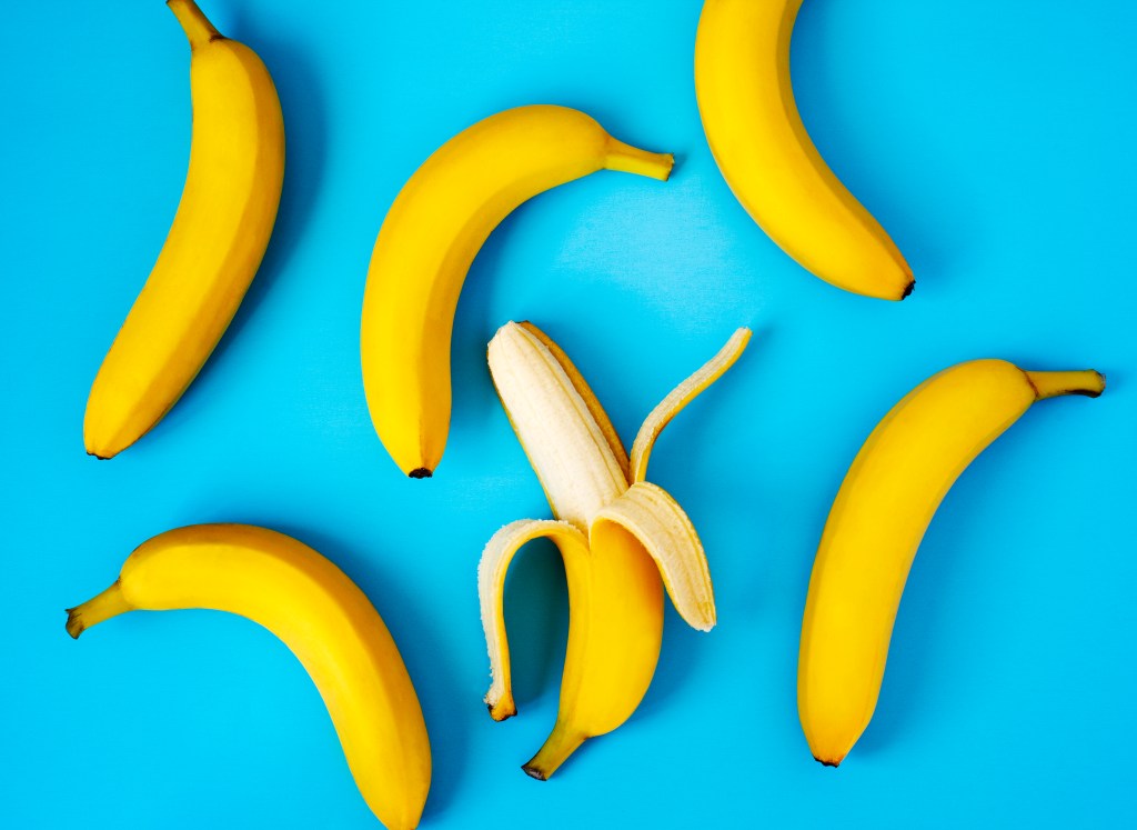 Ripe bananas on blue background