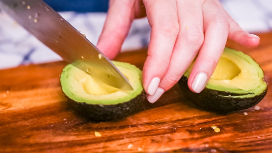 Woman slicing an avocado