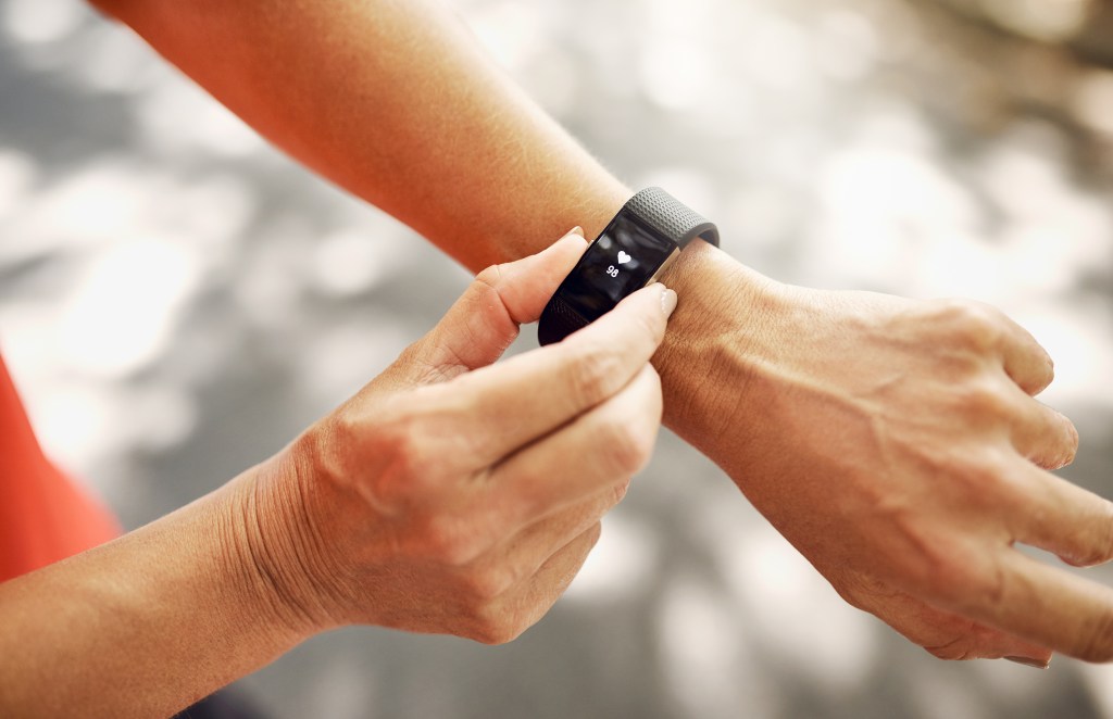 Woman checking fitness tracker on wrist