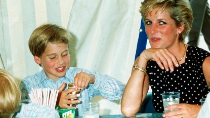 Princess Diana and young Prince William eating at a table