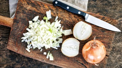 Chopped-onions-on-a-wooden-cutting-board