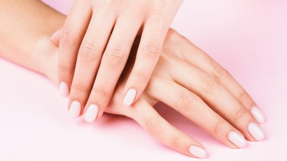 Woman with a gel manicure, who is able to take polish off after learning how to remove gel nails at home