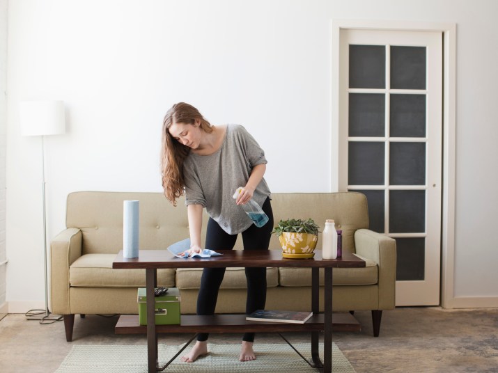 woman cleaning coffee table