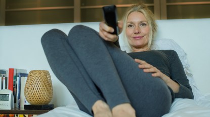 Woman watching TV in bed