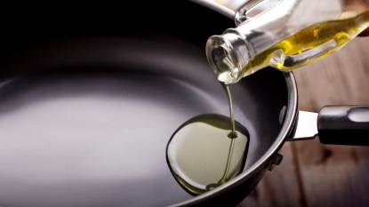 Pouring olive oil into cooking pan