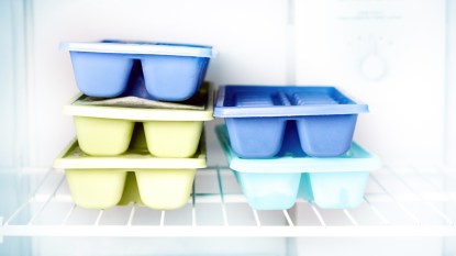 Ice trays stacked in freezer