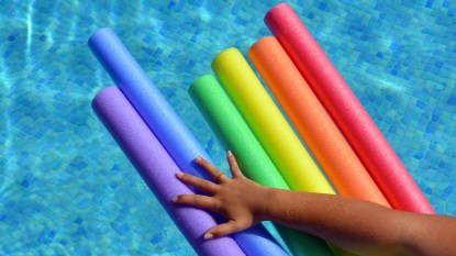 Pool noodles with hand grabbing for them
