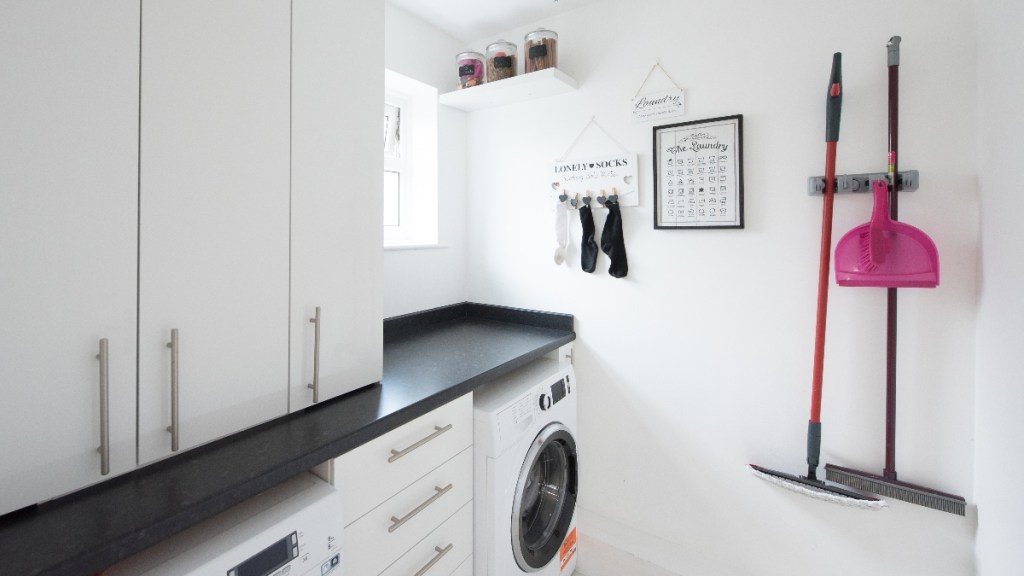 Hanging brooms on the wall is one of many laundry room storage ideas