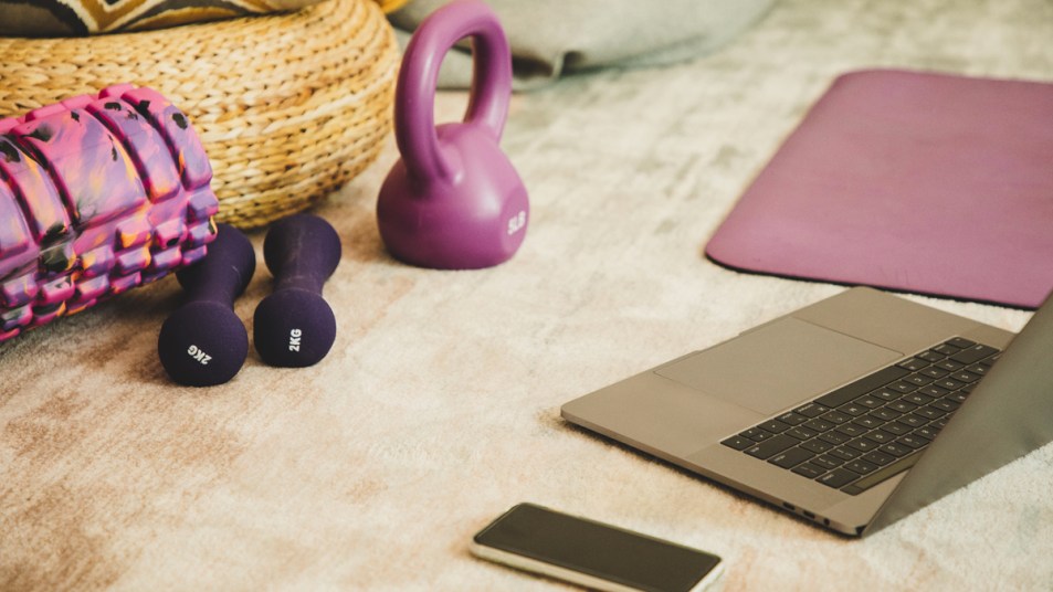 Weights around a laptop and phone