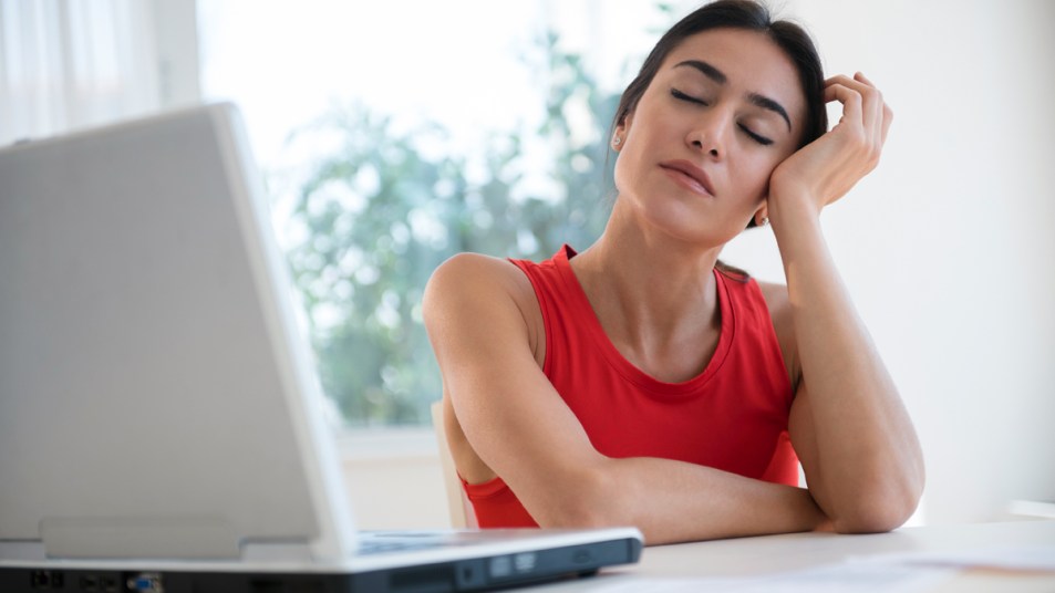 Woman falling asleep at her desk