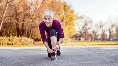 woman tying her running shoes before a run