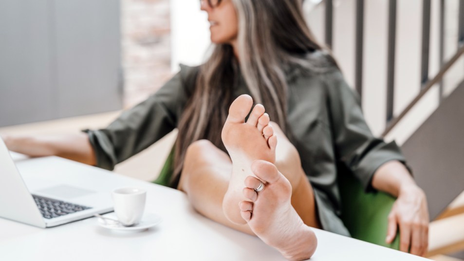Woman with feet up on her desk