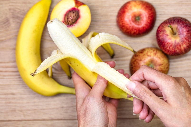 woman peeling banana