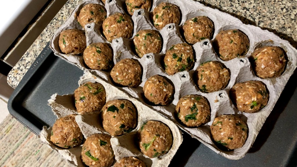 Unbaked meatballs in egg cartons