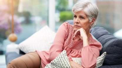Woman looking angry sitting on a couch