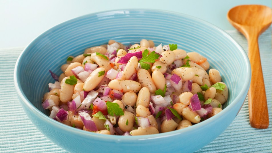 Bowl of cannellini beans with red onions and cilantro