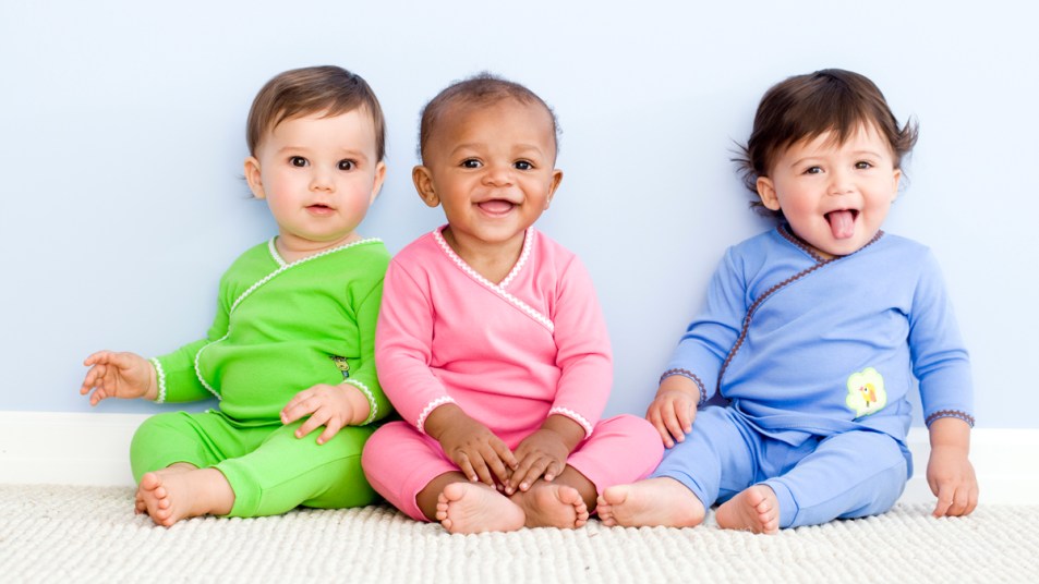 Babies in green, pink, and blue onesies