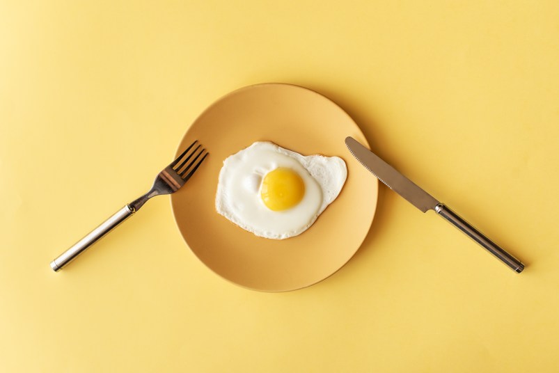 fried egg on yellow background, top view