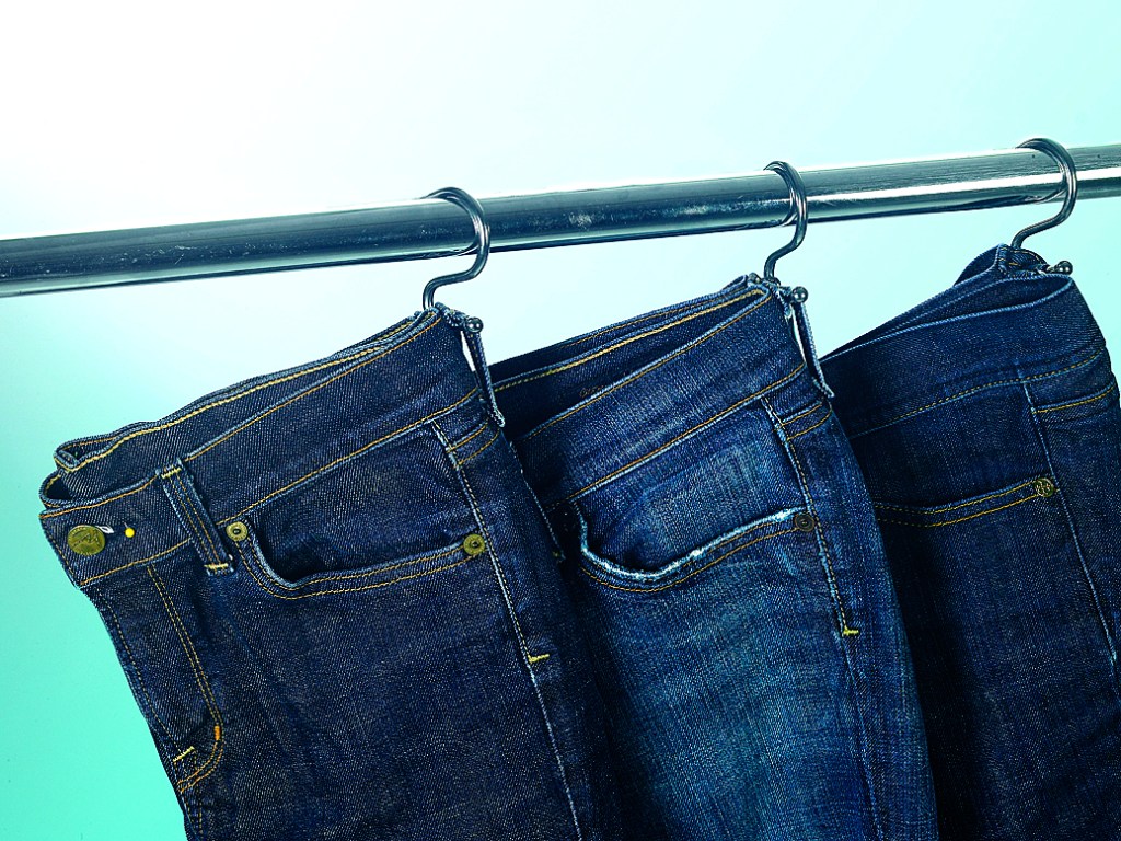 Jeans hanging on s hooks