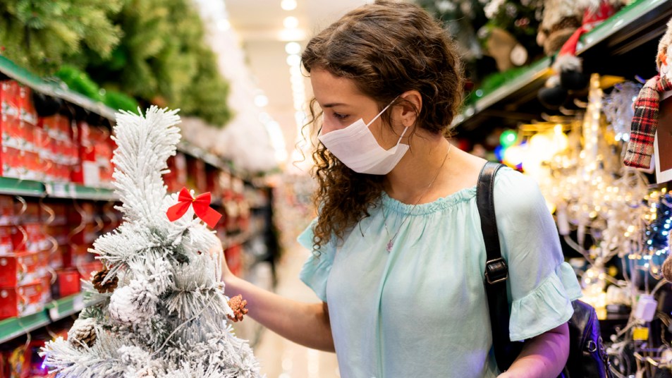 Woman holiday shopping with a mask on