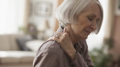 Senior Caucasian woman rubbing her shoulder
